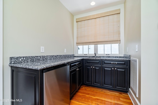 588 E Harborside Rd, Oriental, NC 28571 - kitchen featuring refrigerator, dark cabinets, light wood-style flooring, and a sink