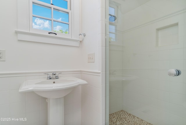 588 E Harborside Rd, Oriental, NC 28571 - full bathroom with a stall shower, tile walls, wainscoting, and a sink
