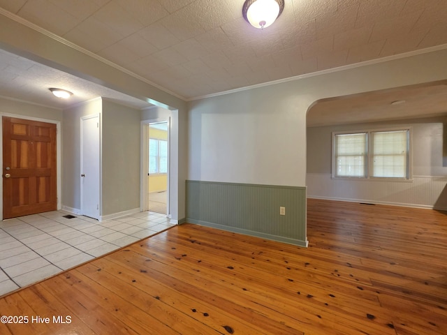 1700 Green Springs Rd, New Bern, NC 28560 - unfurnished room with hardwood / wood-style flooring, arched walkways, wainscoting, and crown molding