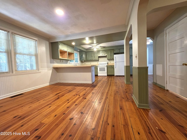 1700 Green Springs Rd, New Bern, NC 28560 - kitchen featuring green cabinetry, white appliances, a peninsula, ornamental molding, and dark wood-style flooring