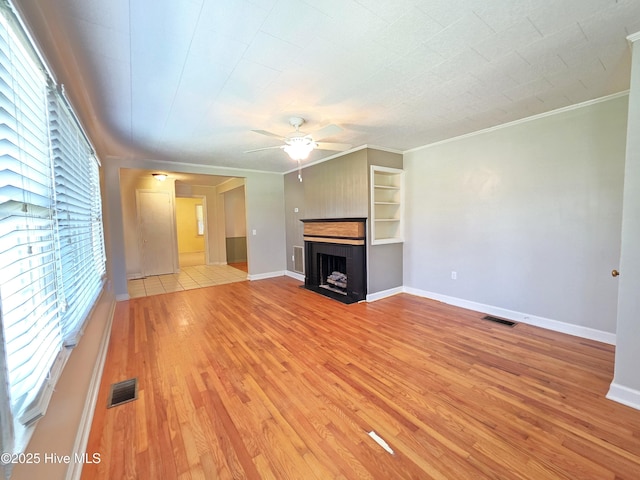 1700 Green Springs Rd, New Bern, NC 28560 - unfurnished living room with crown molding, ceiling fan, a fireplace, light wood-type flooring, and baseboards