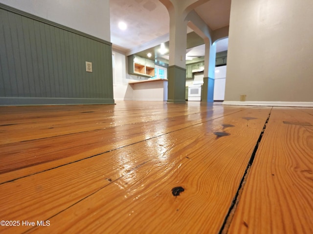 1700 Green Springs Rd, New Bern, NC 28560 - unfurnished living room with arched walkways, baseboards, and hardwood / wood-style flooring