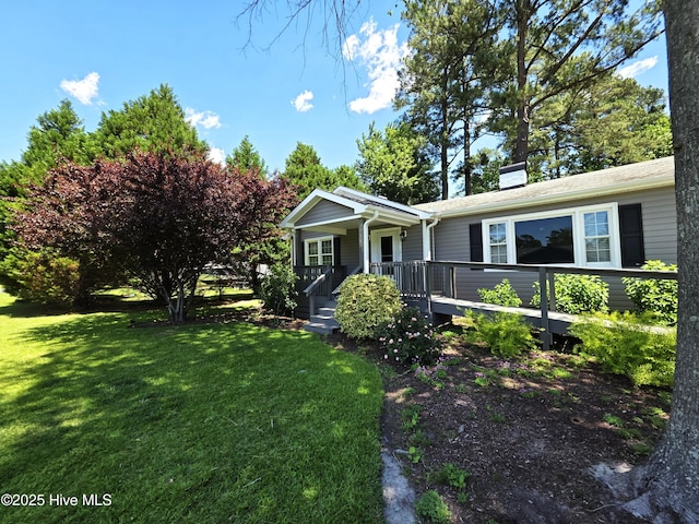1700 Green Springs Rd, New Bern, NC 28560 - view of front of house with a front lawn, covered porch, and a chimney