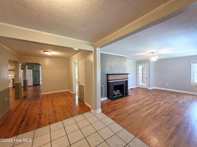 1700 Green Springs Rd, New Bern, NC 28560 - unfurnished living room featuring arched walkways, wood finished floors, crown molding, baseboards, and ceiling fan