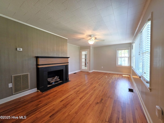 1700 Green Springs Rd, New Bern, NC 28560 - unfurnished living room featuring wood finished floors, ornamental molding, a brick fireplace, a ceiling fan, and baseboards