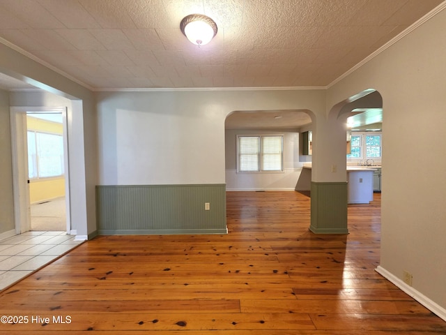 1700 Green Springs Rd, New Bern, NC 28560 - unfurnished room featuring arched walkways, hardwood / wood-style flooring, crown molding, wainscoting, and a sink