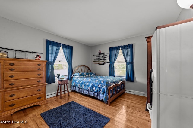 143 Ballard St, Chocowinity, NC 27817 - bedroom featuring multiple windows, light wood-style floors, a baseboard heating unit, and baseboards