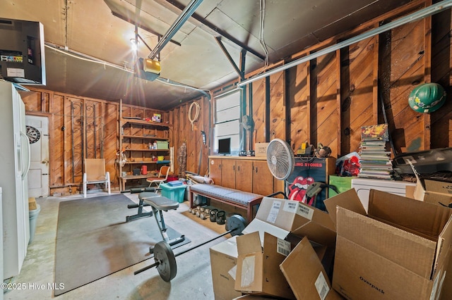 143 Ballard St, Chocowinity, NC 27817 - garage with a garage door opener, wood walls, and a heating unit