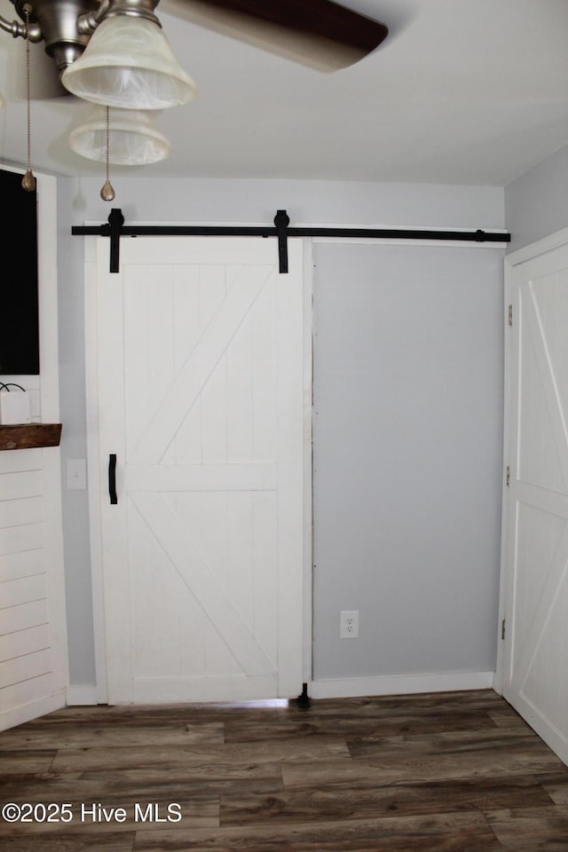 121 Pine Grove Rd, Newport, NC 28570 - interior space with a barn door, wood finished floors, and baseboards