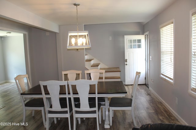 121 Pine Grove Rd, Newport, NC 28570 - dining area featuring wood finished floors, a chandelier, stairs, baseboards, and healthy amount of natural light