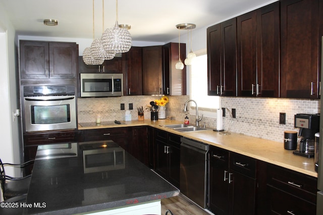 121 Pine Grove Rd, Newport, NC 28570 - kitchen with appliances with stainless steel finishes, a sink, backsplash, hanging light fixtures, and dark brown cabinetry
