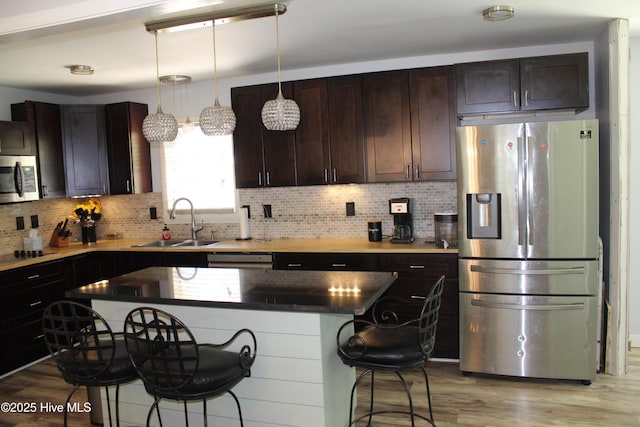 121 Pine Grove Rd, Newport, NC 28570 - kitchen with stainless steel appliances, a sink, a kitchen breakfast bar, and light wood-type flooring