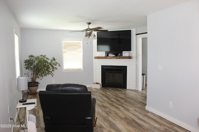 121 Pine Grove Rd, Newport, NC 28570 - living room with ceiling fan, a large fireplace, wood finished floors, and baseboards