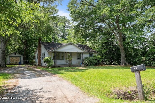 167 Ballard St, Chocowinity, NC 27817 - view of front of property with dirt driveway, an outdoor structure, covered porch, a front yard, and a detached garage
