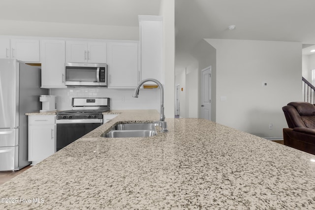 119 Perrytown Loop Rd, New Bern, NC 28562 - kitchen with appliances with stainless steel finishes, a sink, light stone counters, and white cabinetry