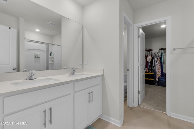 119 Perrytown Loop Rd, New Bern, NC 28562 - full bath with double vanity, toilet, a stall shower, a spacious closet, and baseboards