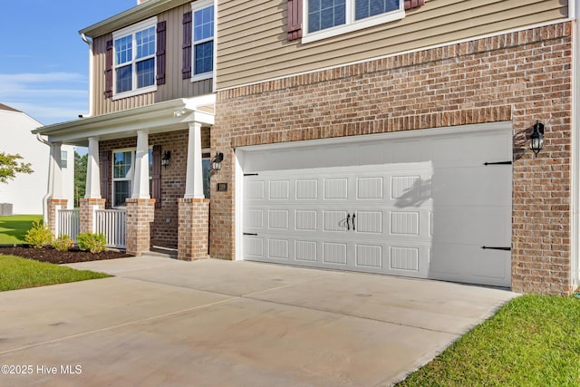 119 Perrytown Loop Rd, New Bern, NC 28562 - view of front facade featuring brick siding, concrete driveway, covered porch, and an attached garage