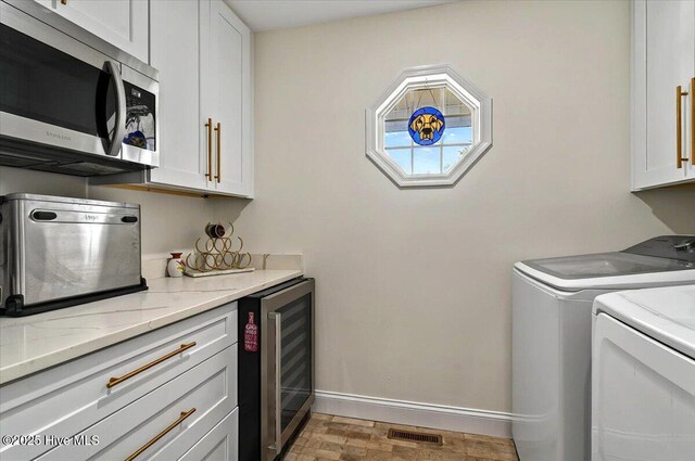 5892 Lycia Ln SW, Ocean Isle Beach, NC 28469 - washroom featuring beverage cooler, cabinet space, washer and clothes dryer, and baseboards