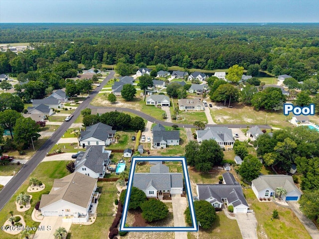 5892 Lycia Ln SW, Ocean Isle Beach, NC 28469 - aerial perspective of suburban area with property boundaries highlighted and a forest