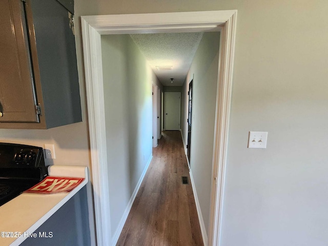 1007 Edmondson Ave, Tarboro, NC 27886 - hallway with wood finished floors, baseboards, washer / clothes dryer, and a textured ceiling