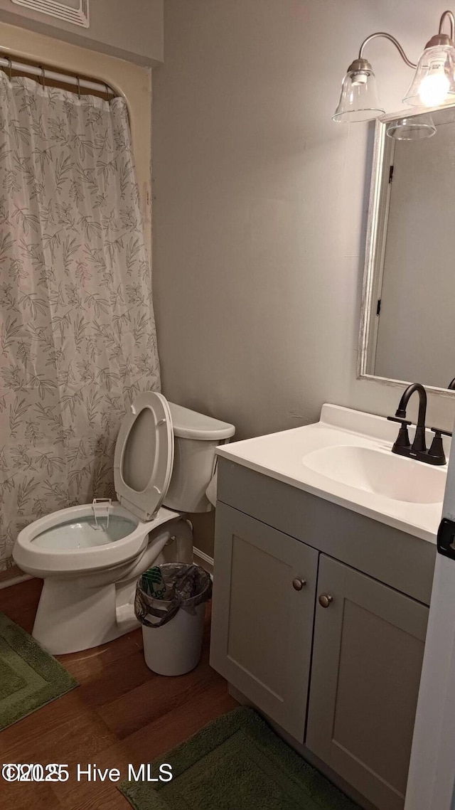 1007 Edmondson Ave, Tarboro, NC 27886 - bathroom featuring vanity, wood finished floors, toilet, and a shower with shower curtain