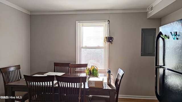 1007 Edmondson Ave, Tarboro, NC 27886 - dining room with electric panel, ornamental molding, wood finished floors, and baseboards