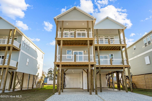 138 Sea Gull Ln, North Topsail Beach, NC 28460 - rear view of house with a carport, a balcony, and driveway
