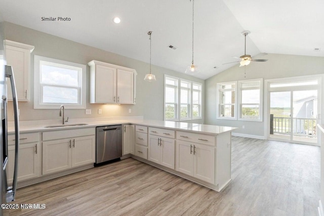 138 Sea Gull Ln, North Topsail Beach, NC 28460 - kitchen with stainless steel appliances, a sink, light wood-style floors, a peninsula, and lofted ceiling