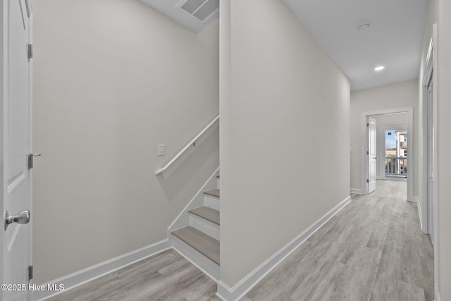 138 Sea Gull Ln, North Topsail Beach, NC 28460 - hallway featuring light wood finished floors, baseboards, and stairs