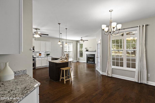 113 Percy Padgett Ct, Holly Ridge, NC 28445 - kitchen with ceiling fan, open floor plan, white cabinets, dark wood-style floors, and a chandelier