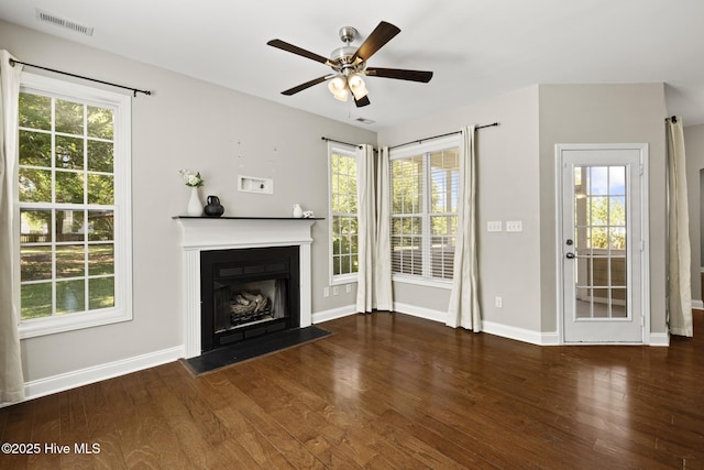 113 Percy Padgett Ct, Holly Ridge, NC 28445 - unfurnished living room featuring wood finished floors, ceiling fan, a fireplace with flush hearth, and plenty of natural light