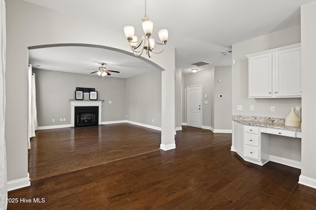113 Percy Padgett Ct, Holly Ridge, NC 28445 - unfurnished living room with ceiling fan, arched walkways, dark wood finished floors, a fireplace with flush hearth, and baseboards