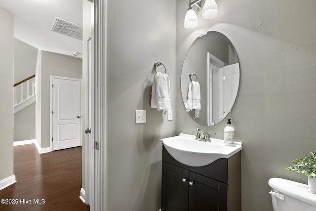 113 Percy Padgett Ct, Holly Ridge, NC 28445 - half bath with vanity, toilet, wood finished floors, and baseboards