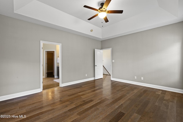 113 Percy Padgett Ct, Holly Ridge, NC 28445 - unfurnished bedroom with a raised ceiling, dark wood-style flooring, baseboards, and ensuite bathroom