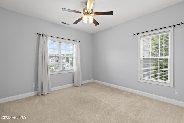 113 Percy Padgett Ct, Holly Ridge, NC 28445 - empty room featuring a ceiling fan, light colored carpet, plenty of natural light, and baseboards