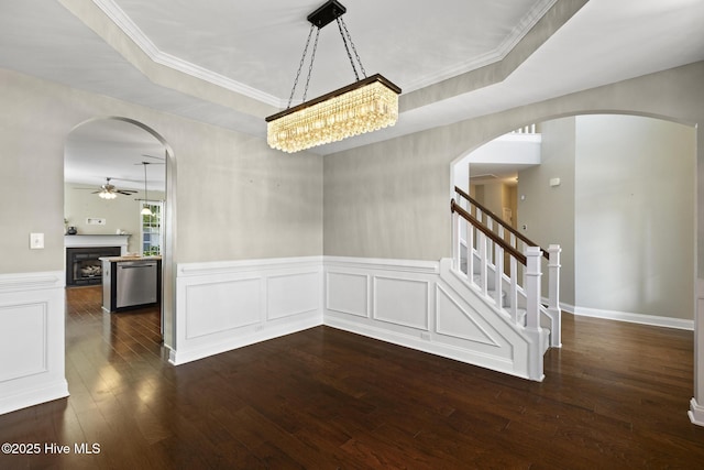 113 Percy Padgett Ct, Holly Ridge, NC 28445 - unfurnished dining area featuring ceiling fan, arched walkways, hardwood / wood-style floors, stairway, and wainscoting