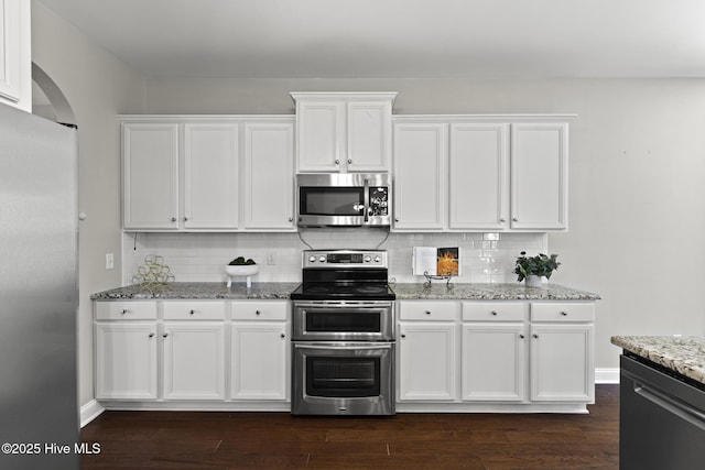 113 Percy Padgett Ct, Holly Ridge, NC 28445 - kitchen featuring appliances with stainless steel finishes, white cabinets, and decorative backsplash