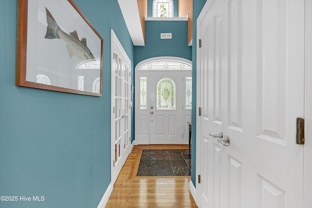 3878 White Blossom Cir, Southport, NC 28461 - foyer entrance with wood finished floors, french doors, and baseboards