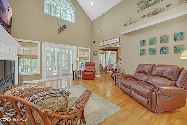 3878 White Blossom Cir, Southport, NC 28461 - living area with healthy amount of natural light, high vaulted ceiling, light wood-style floors, a fireplace, and recessed lighting