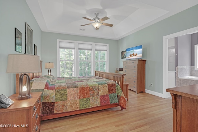 3878 White Blossom Cir, Southport, NC 28461 - bedroom with a raised ceiling, light wood-style flooring, baseboards, and a ceiling fan