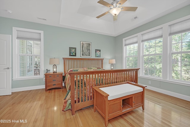 3878 White Blossom Cir, Southport, NC 28461 - bedroom with multiple windows, light wood finished floors, and baseboards