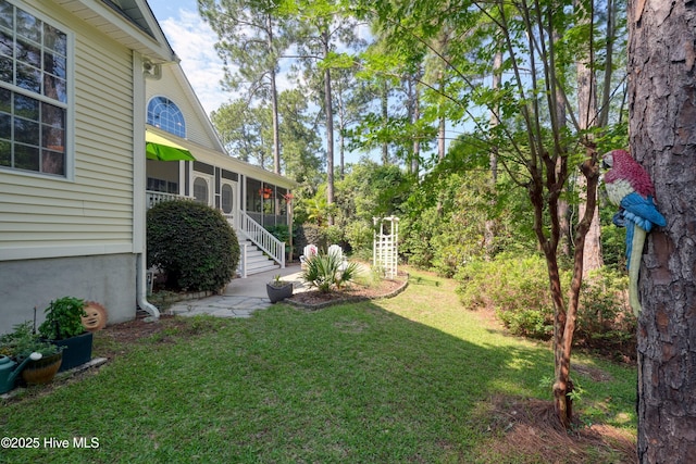 3878 White Blossom Cir, Southport, NC 28461 - view of grassy yard featuring a sunroom
