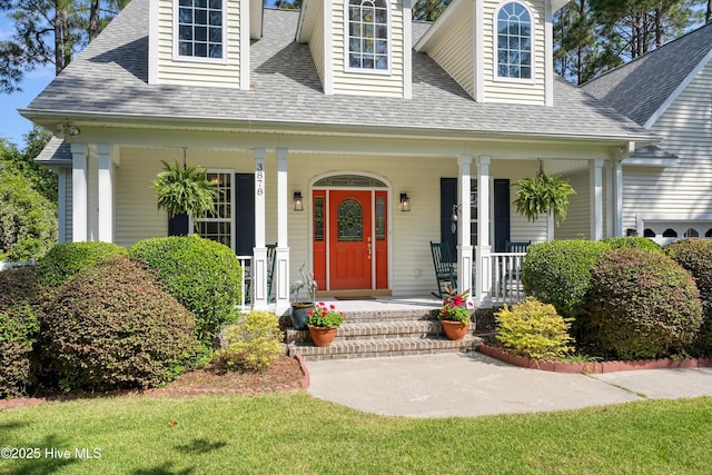 3878 White Blossom Cir, Southport, NC 28461 - view of front of property featuring a porch and a shingled roof