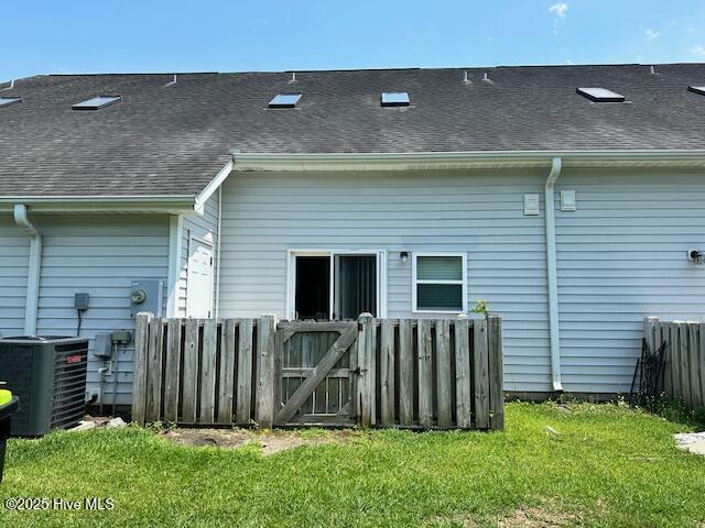 104 Lincoln Place Cir, Leland, NC 28451 - rear view of house with central AC, a shingled roof, and a gate
