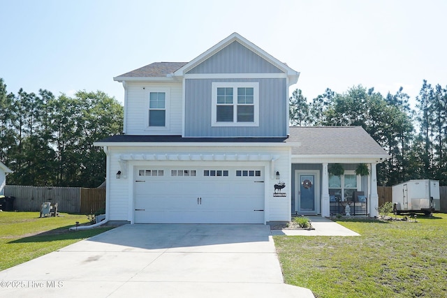 215 Chestwood Dr, Hubert, NC 28539 - traditional home featuring concrete driveway, an attached garage, board and batten siding, and a porch