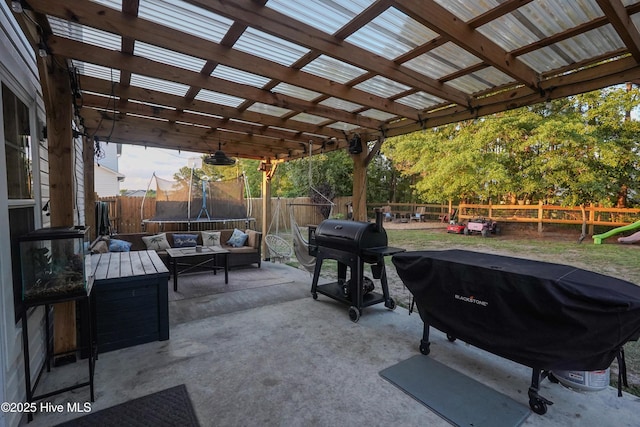 215 Chestwood Dr, Hubert, NC 28539 - fenced backyard featuring a trampoline, a patio, grilling area, and an outdoor living space