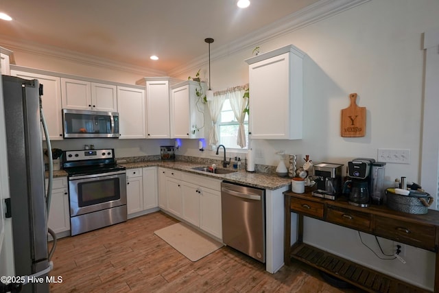 215 Chestwood Dr, Hubert, NC 28539 - kitchen with appliances with stainless steel finishes, a sink, crown molding, stone countertops, and white cabinetry