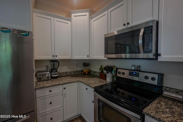 215 Chestwood Dr, Hubert, NC 28539 - kitchen featuring appliances with stainless steel finishes, white cabinets, and dark stone counters