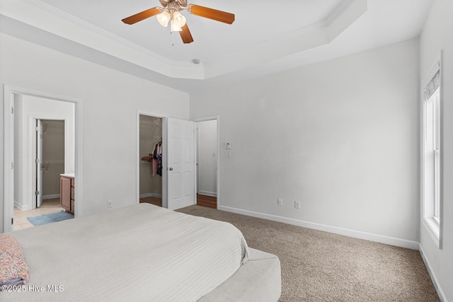 317 Inverness Dr, Hubert, NC 28539 - bedroom with a spacious closet, baseboards, light colored carpet, a raised ceiling, and crown molding