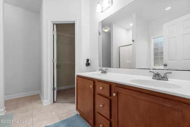 317 Inverness Dr, Hubert, NC 28539 - full bath featuring double vanity, baseboards, a walk in closet, and tile patterned floors